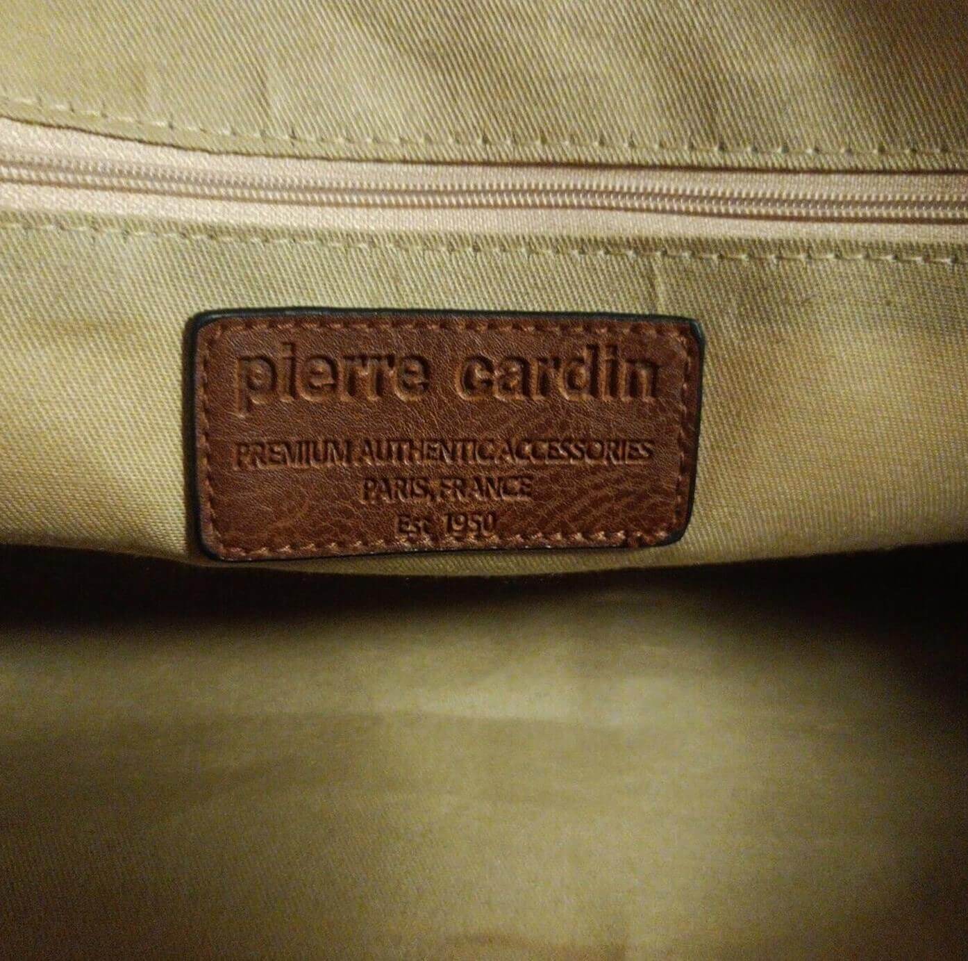 Beige bag with a brown leather label featuring 'Pierre Cardin' branding.
