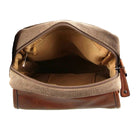 Brown leather and canvas toiletry bag with open top on a white background